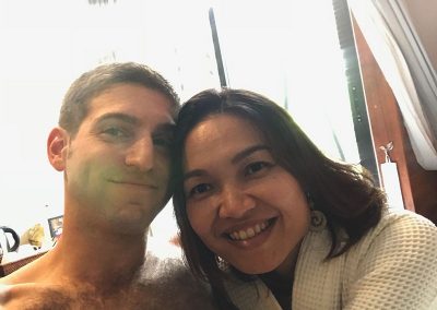 honeymoon couple travelers smiling selfie by the window in Butterfly Pea hotel room