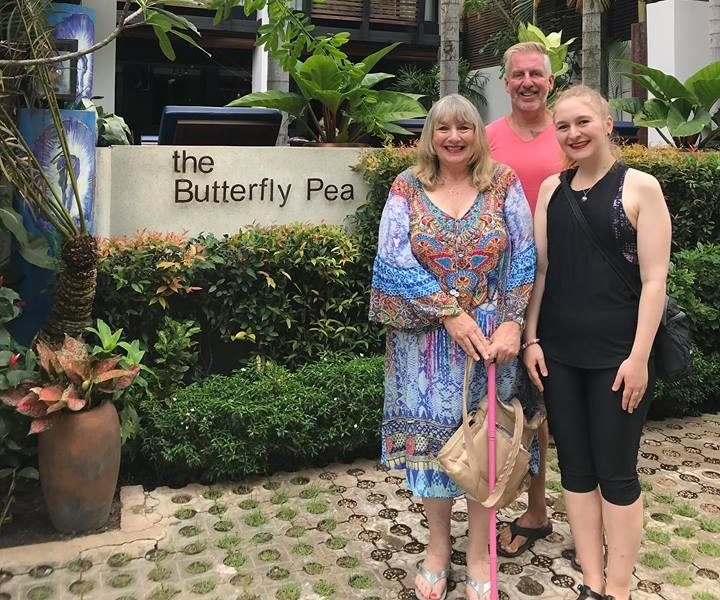 happy guests standing in front of the butterfly pea boutique hotel