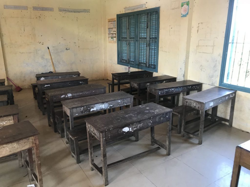 dark brown wooden school tables in a school Prek Toal, Siem Reap